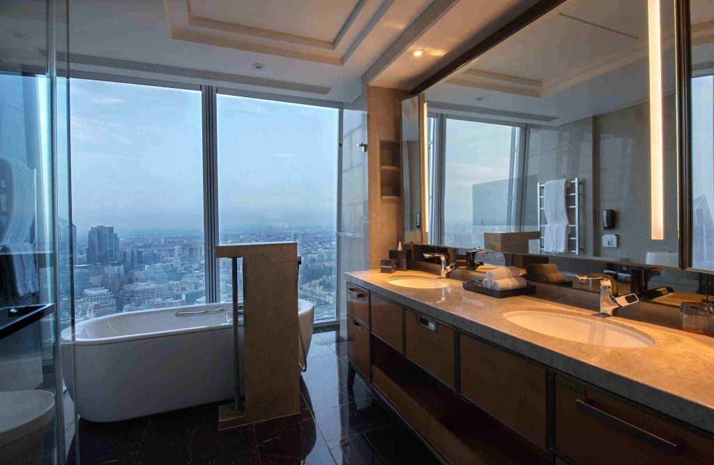 Luxury bathroom at Shangri-La Hotel, London with freestanding tub and vanity under soft lighting
